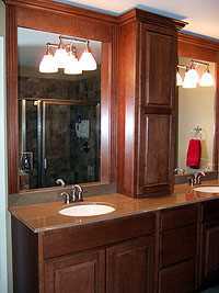 cherry cabinets and granite countertops in remodeled bathroom