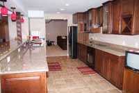 basement kitchen with flooring and wine rack