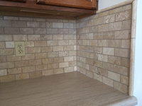 remodeled kitchen with brick backsplash