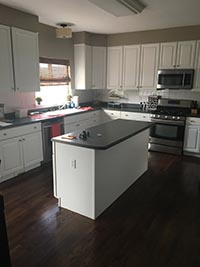 black counters with white cabinets