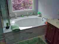 bath tub installation with faucets and plumbing