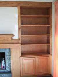 custom oak shelves and cabinet match hearth