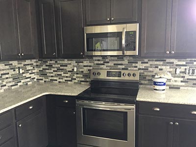 Black, white and gray kitchen tile backsplash