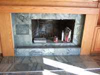 marble hearth installation with oak surround and trim