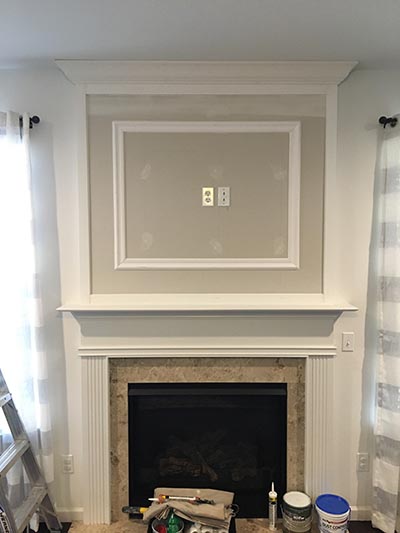 framed TV area over fireplace
