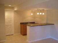 wet bar and lighting in finished basement